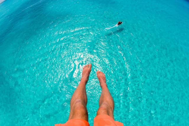 Cabbage Beach: Parasailing over Clear Blue Waters