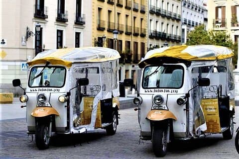 Tour of Historic and Modern Madrid with a guide in a yellow tuk tuk