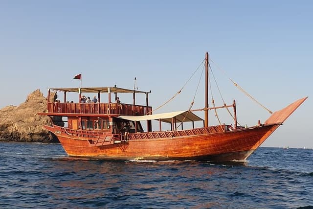 Omani Traditional Dhow Cruise: Sunset and Muscat Coastal View