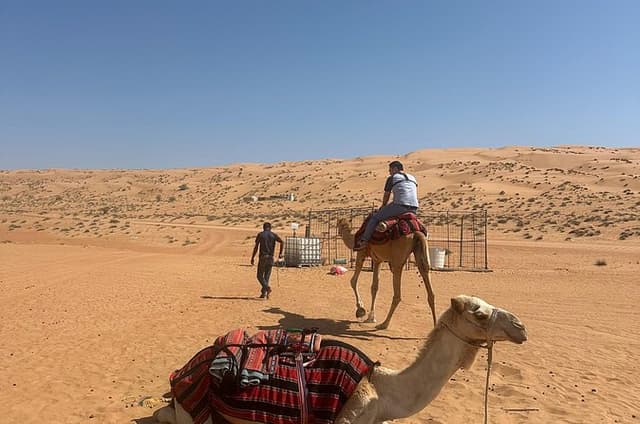 Muscat: Private Bidiya Desert Sunset Camel Ride with Transfer