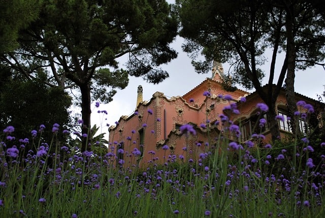 antoni gaudi museum inside parque guell in the midst of a beautiful flower forest