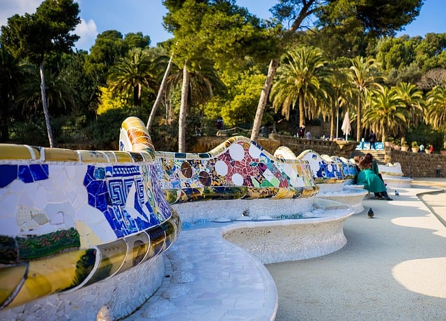 plaça de la natura, a large esplanade at the center of parque guell, tiled art and benches. in the shape of an amphitheatre.