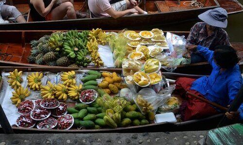 Vendors sell fruit on a boat in Bangkok. 
