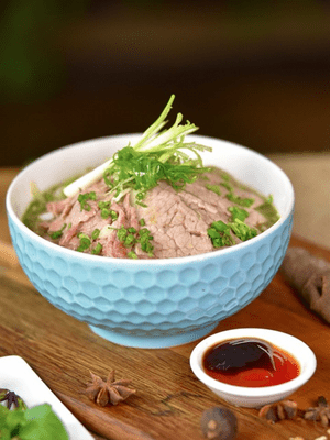 Delicious slices of rare beef over the beef noodle soup