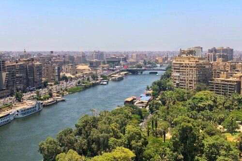 aerial view of Zamalek District on the right and Agouza District on the left with the Nile River in Cairo, Egypt between them.