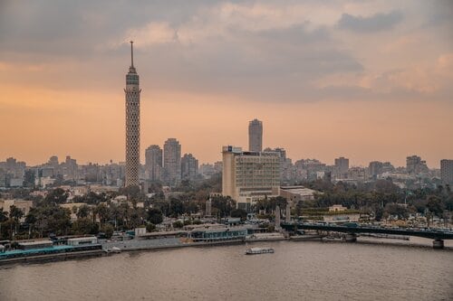 Cairo Tower surrounded by buildings and the Nile