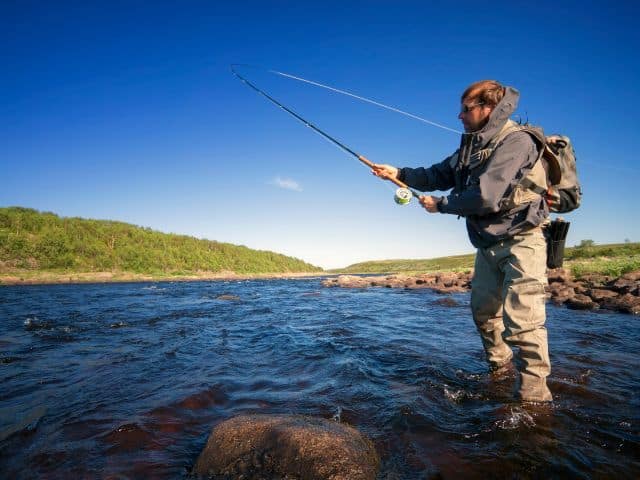 An angler casting his fly rod