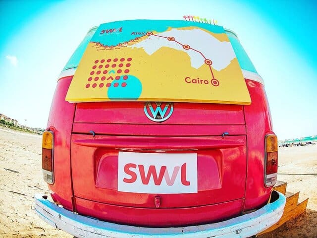 A picture of a red bus with the word Swvl on it