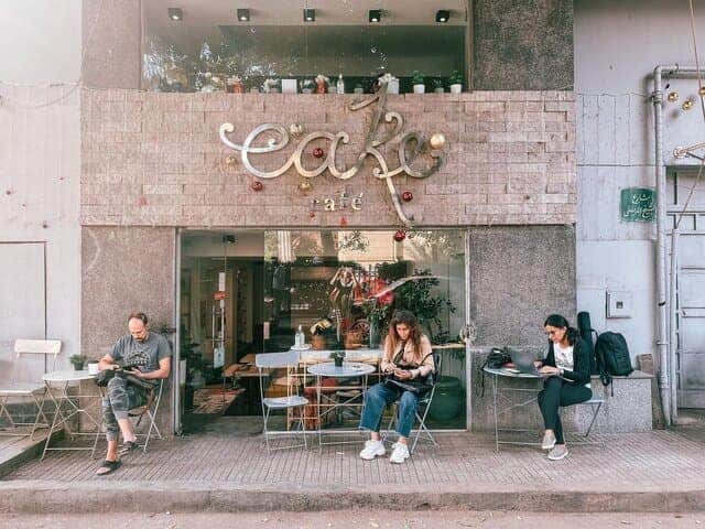 A picture of people sitting outside of Cake Café in Egypt.
