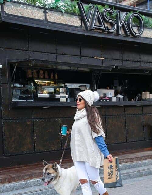 A picture of a woman walking with a dog outside of Vasko in Egypt.