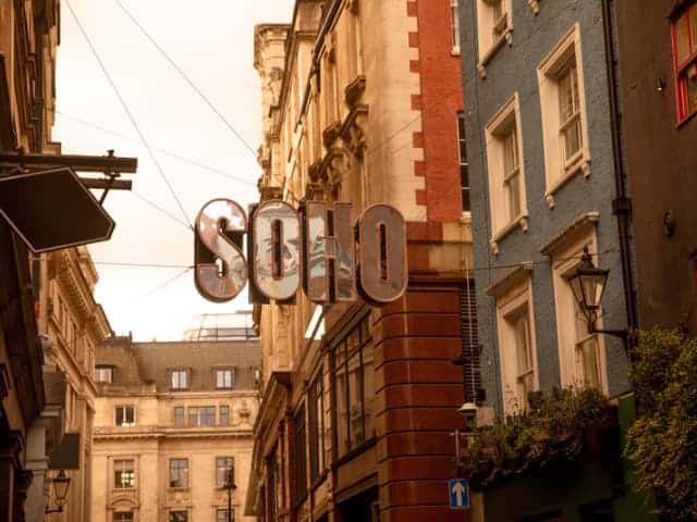 A picture of a sign saying Soho inside of Soho in London.