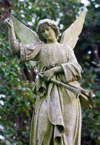 A picture of a statue inside of Highgate Cemetery in London.