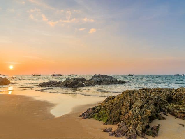 A picture of a Khao Lak beach in Thailand, which is a slow travel destination, during sunset.