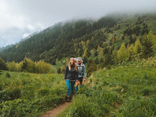 A picture of a family-hiking through mountains in foggy weather.