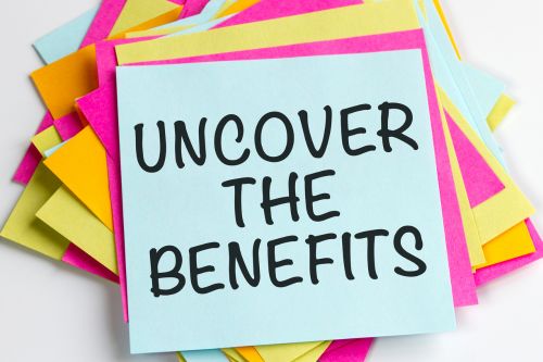 A picture of the words "UNCOVER THE BENEFITS" written on a colorful note.