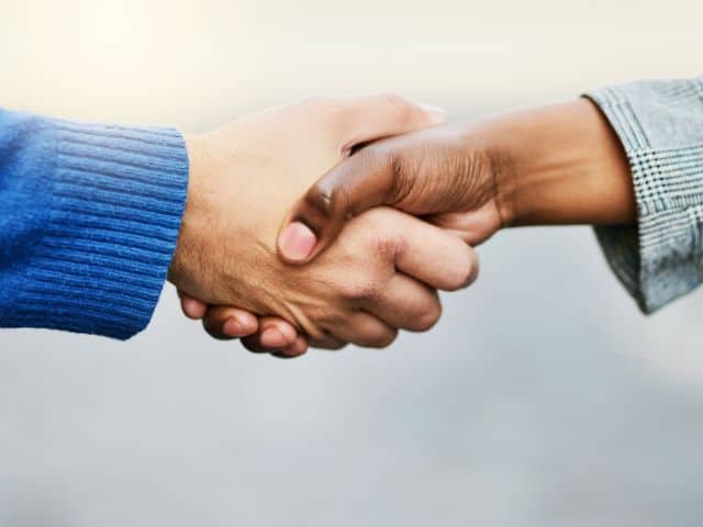 A picture of two people doing a handshake to indicate meeting new people.