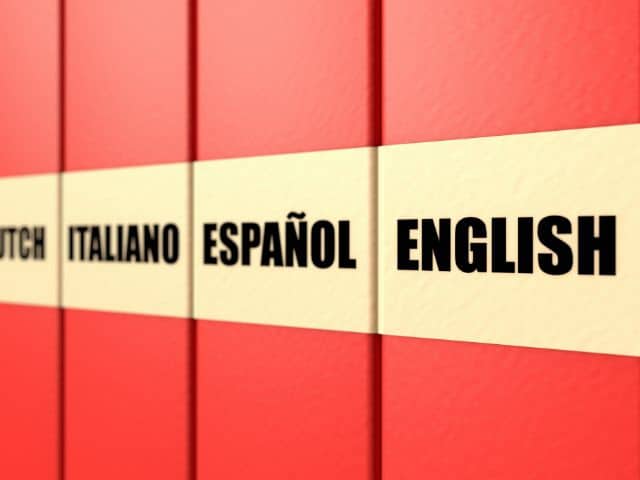 A picture of different language names, including English, written on red book spines.