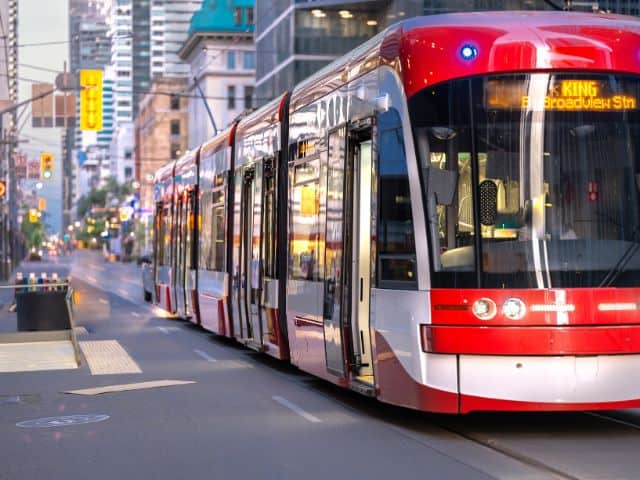 A picture of a red bus in Downtown Toronto in Canada.