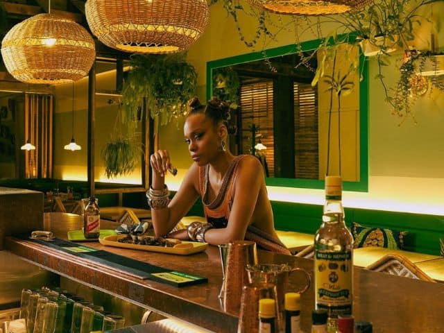 A picture of a woman sitting at Chubby’s Jamaican Kitchen in Toronto, Canada.