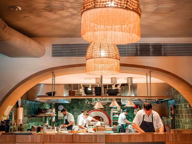 A picture of the staff working in the kitchen at Byblos in Toronto, Canada.