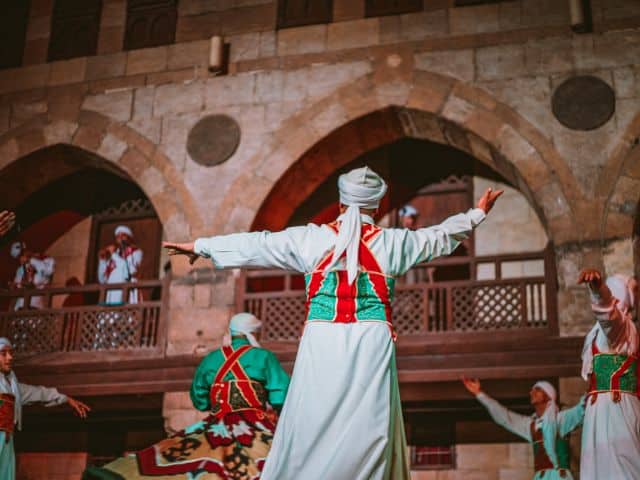 A picture of a group of Egyptian men dancing together.