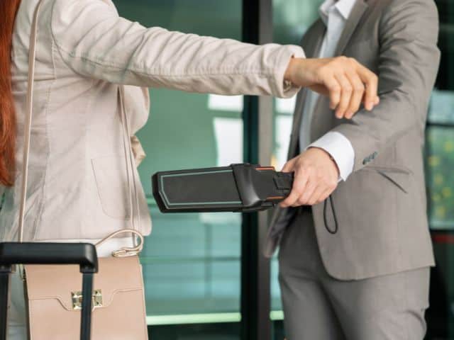 A picture of a woman going through a security check.