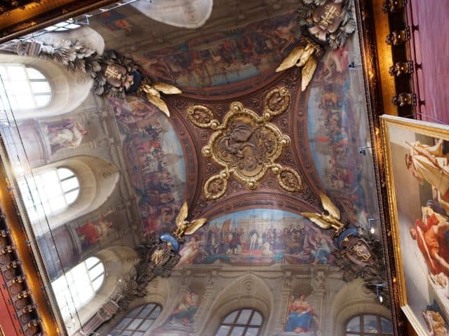 A picture of one of the ceilings inside of the Louvre Museum in Paris, France.