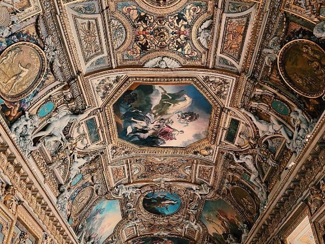 A picture of the ceiling of The Apollo Gallery inside of the Louvre Museum in Paris, France.