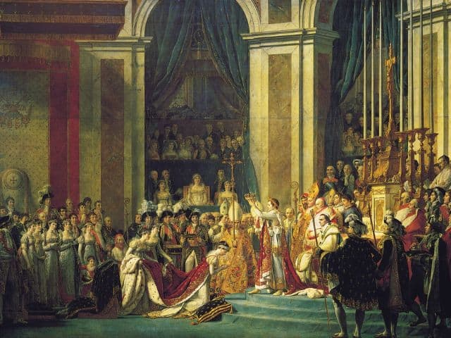 A picture of The Coronation of Napoleon painting inside of the Louvre Museum in Paris, France.