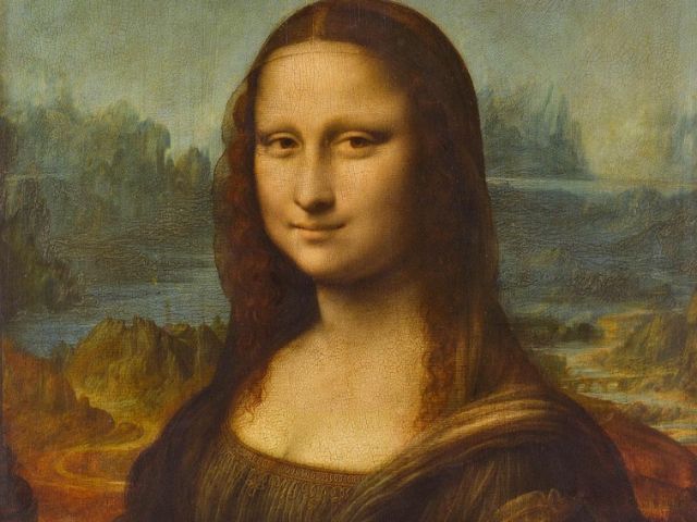 A picture of Mona Lisa inside of the Louvre Museum in Paris, France.