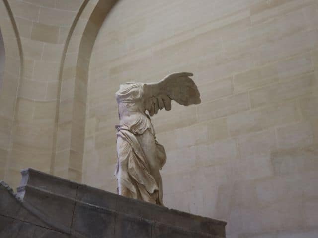 A picture of the Winged Victory of Samothrace inside of the Louvre Museum in Paris, France.