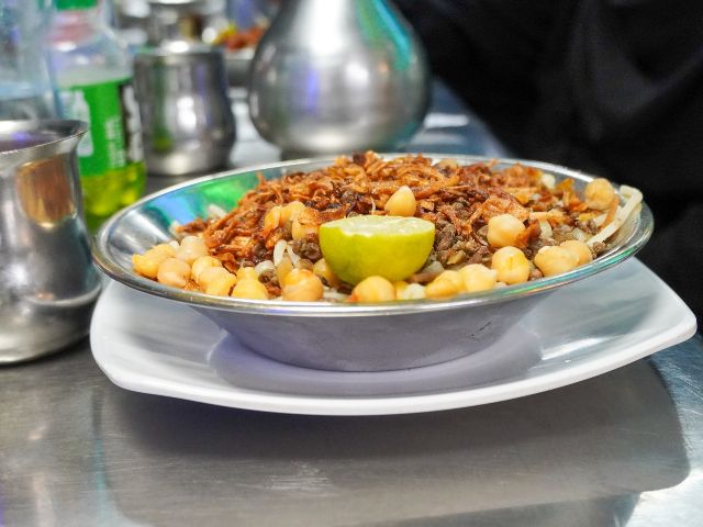 A picture of a koshary plate that is served in a restaurant in Egypt.