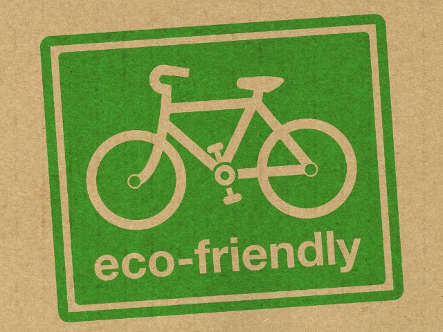 A picture of a green stamp with the words eco-friendly on it and an image of a bicycle on it too.