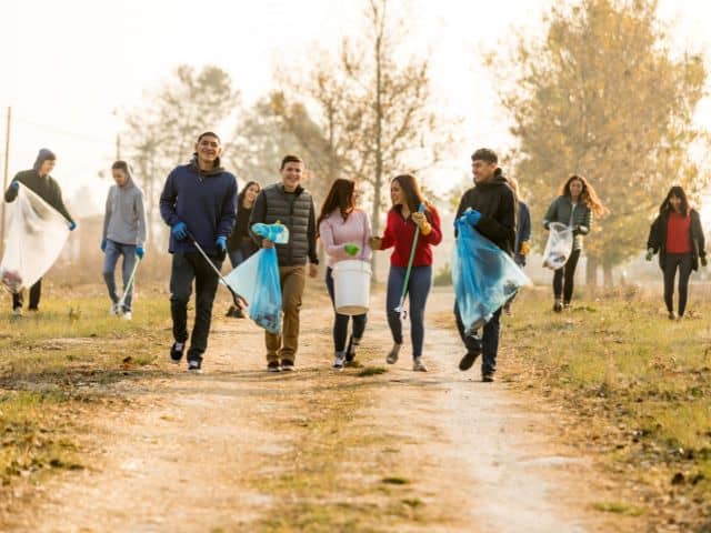 A picture of a local community cleaning the land.