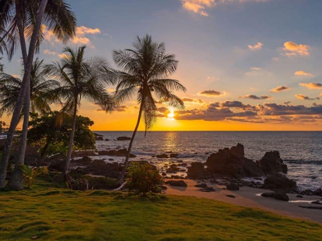 A picture of a sunset on a beach in Costa Rica. sustainable travel destinations.