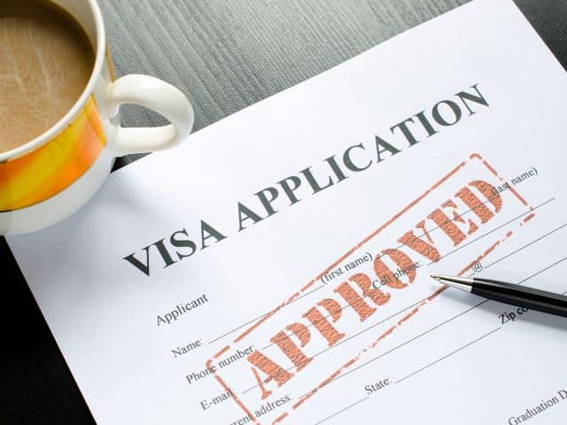 A picture of a visa application with a red "approved" on it.