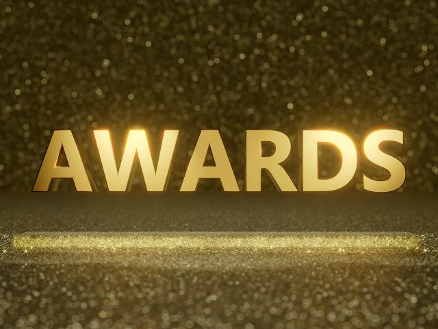 A picture of the word Awards written in gold.