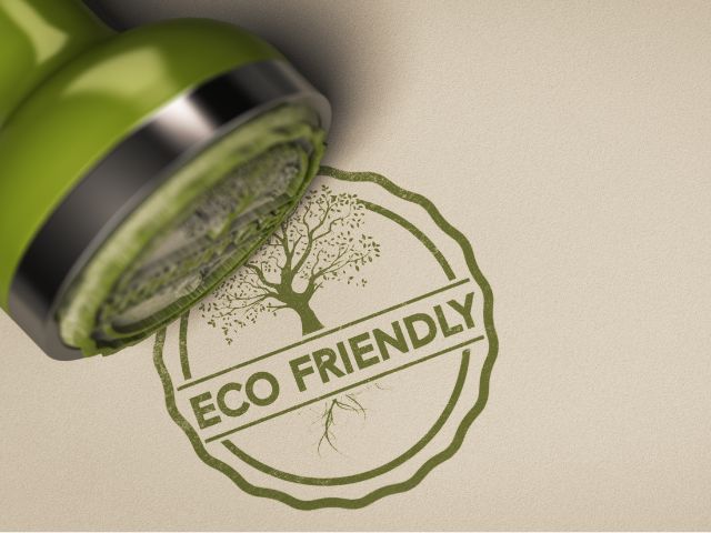 A picture of the words eco-friendly made by a stamp. sustainable travel destinations.