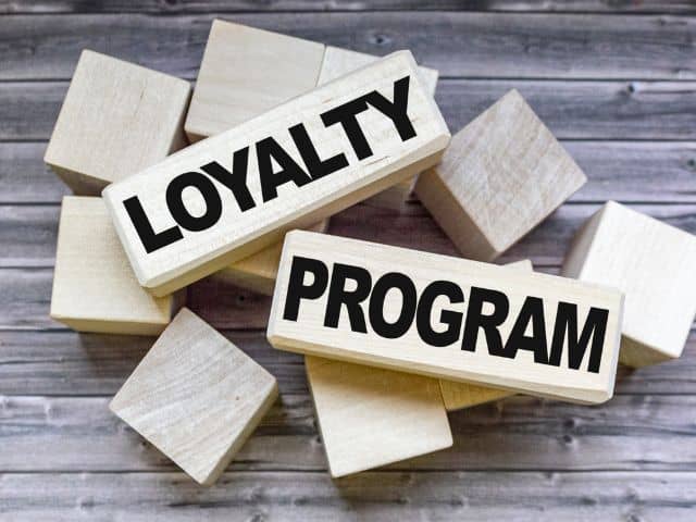 A picture of the words "Loyalty program" written on wooden blocks.