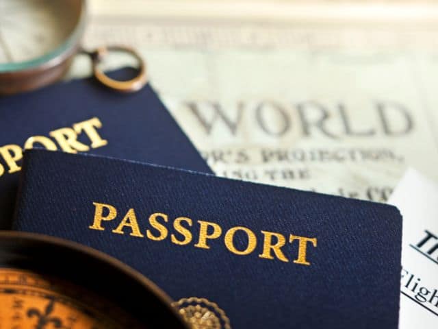 A picture of two passports with the word "world" written in the background.