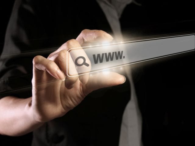 A picture of a hand holding a virtual screen with WWW. written on it.