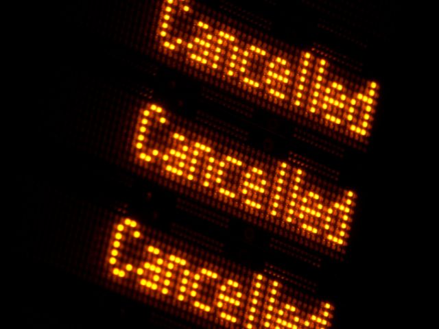 A picture of an electronic display board showing the word cancelled.