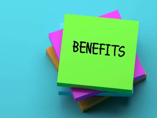 A picture of the words "Benefits" written on a green post it note.