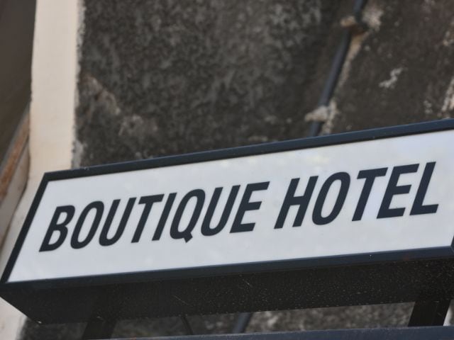 A picture of a boutique hotel on a sign.