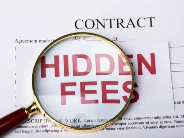 A picture of the words "hidden fees" under a magnifying glass.