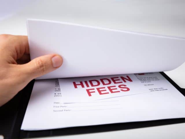 A picture of the words "hidden fees" written on a contract.