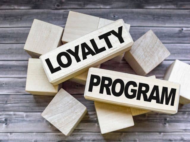 A picture of the words "loyalty program" written on wooden blocks.